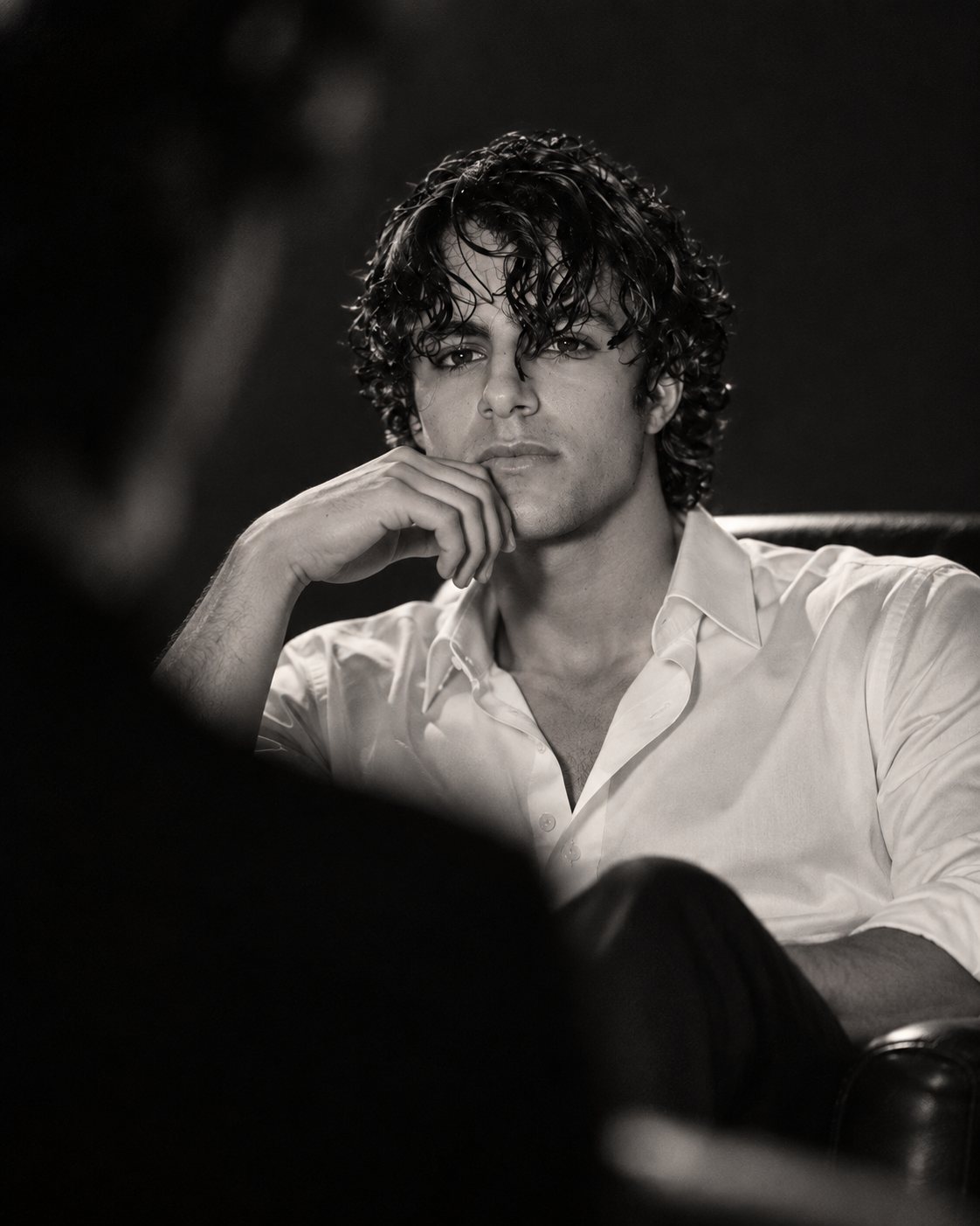 Black and white portrait of Khalid, hand resting on his chin